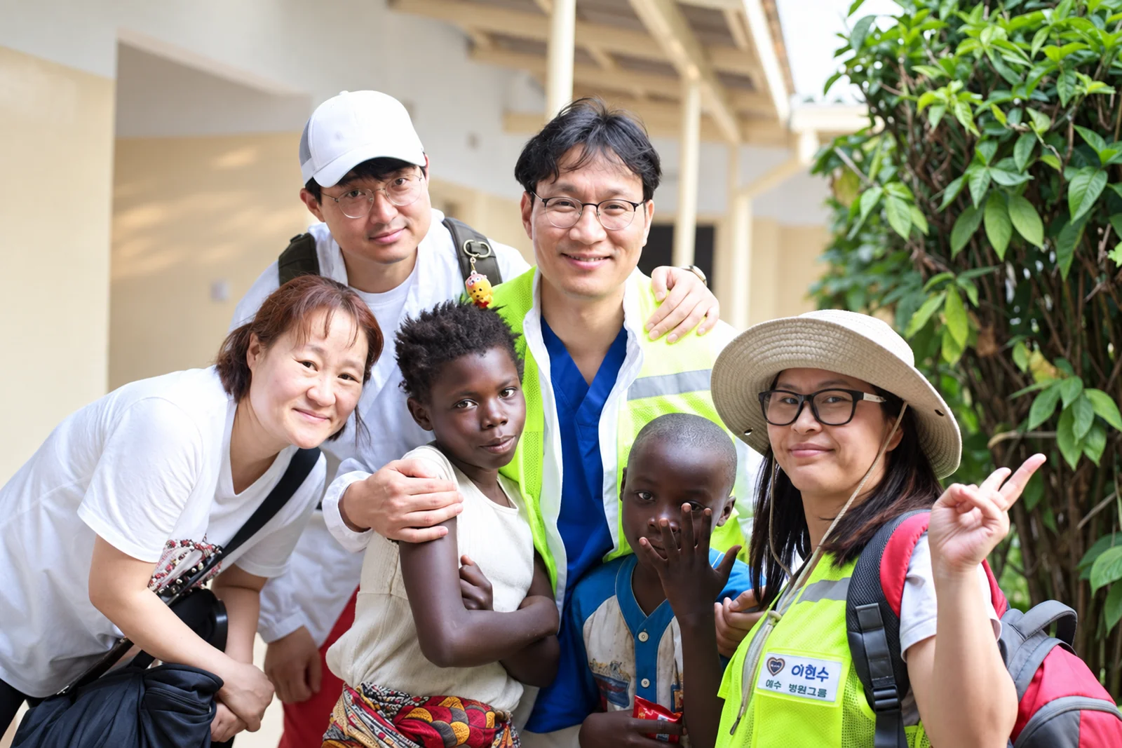 Dr John Paul Lee with a group of colleagues and children
