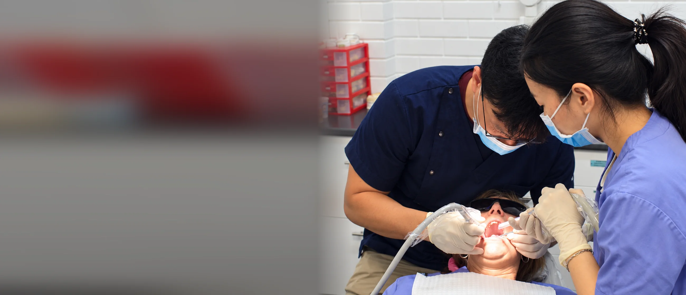 Dr John Paul Lee and a dental assistant treating a patient at New’Gen Dental Surgery